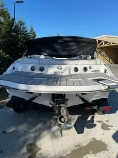 Slide: The Image of 2023 Tahoe 210 Si Limited boat, rear view, on a trailer in a sunny outdoor setting. - 1