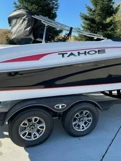 Slide: The Image of 2023 Tahoe 210 Si Limited boat on trailer, featuring sleek design and dual wheels. - 4