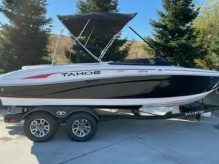 Slide: The Image of 2023 Tahoe 210 Si Limited boat on trailer, parked outdoors. - 7