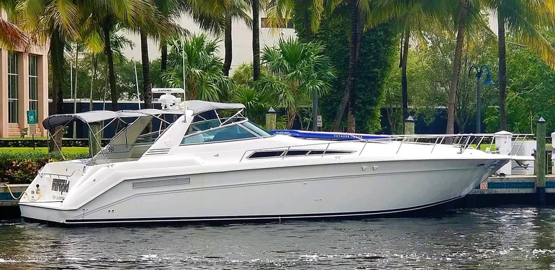 The Image of 1993 Sea Ray Sundancer yacht docked by palm trees. - 0