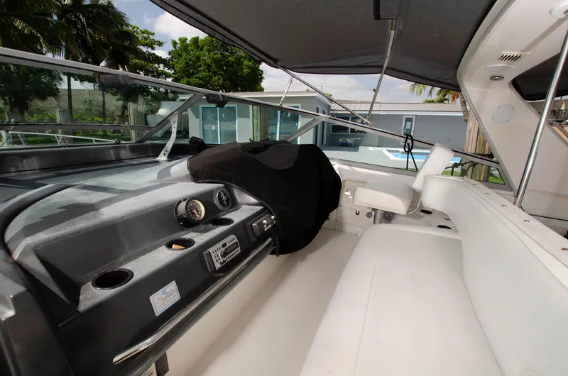 Slide: The Image of 1993 Sea Ray Sundancer cockpit with steering wheel and seating area. - 12