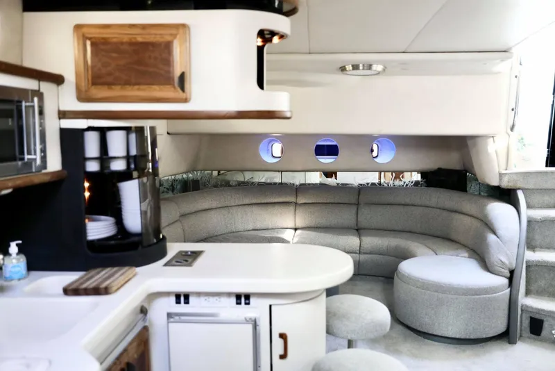 Slide: The Image of 1993 Sea Ray Sundancer interior with kitchen and cozy seating area. - 17
