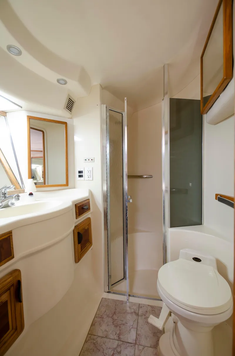 Slide: The Image of Bathroom interior of a 1993 Sea Ray Sundancer yacht with shower and toilet. - 22