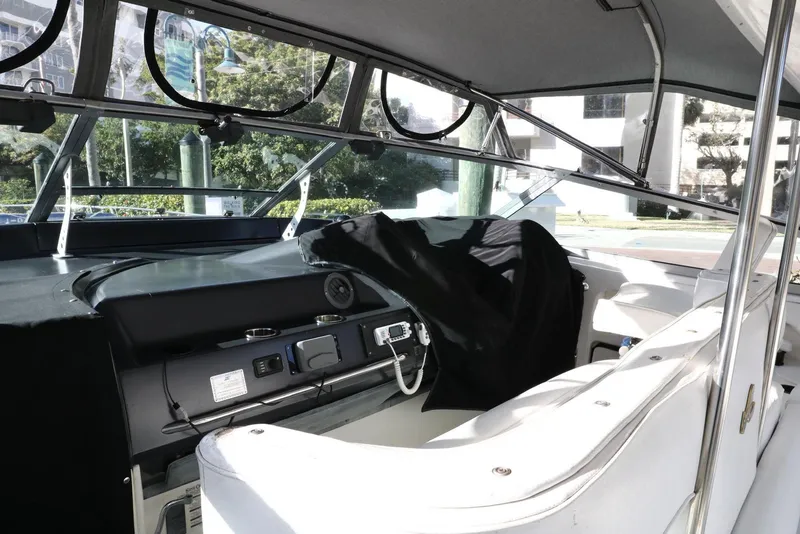 Slide: The Image of 1993 Sea Ray Sundancer boat interior with helm and seating area. - 26