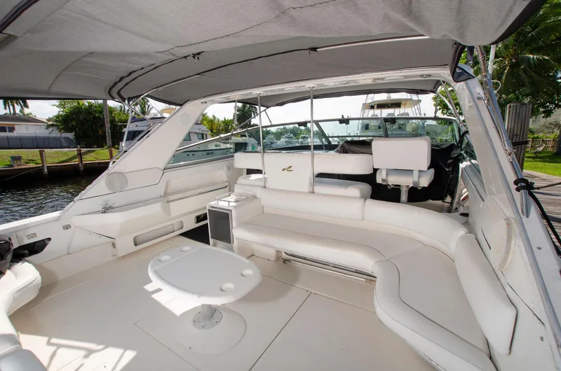 Slide: The Image of 1993 Sea Ray Sundancer boat interior with white seating and table. - 7