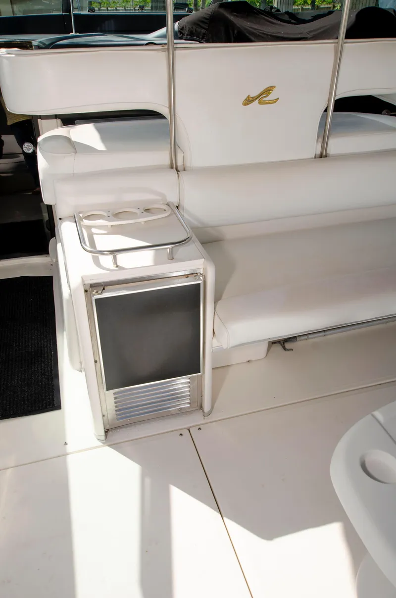 Slide: The Image of 1993 Sea Ray Sundancer boat interior with seating and mini fridge. - 9