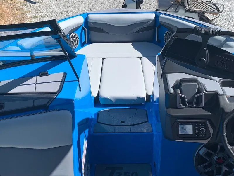 Slide: The Image of 2023 Axis T250 boat interior with blue and gray seating and modern dashboard. - 10