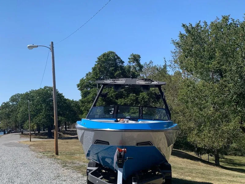 Slide: The Image of 2023 Axis T250 boat on trailer in a park setting. - 15