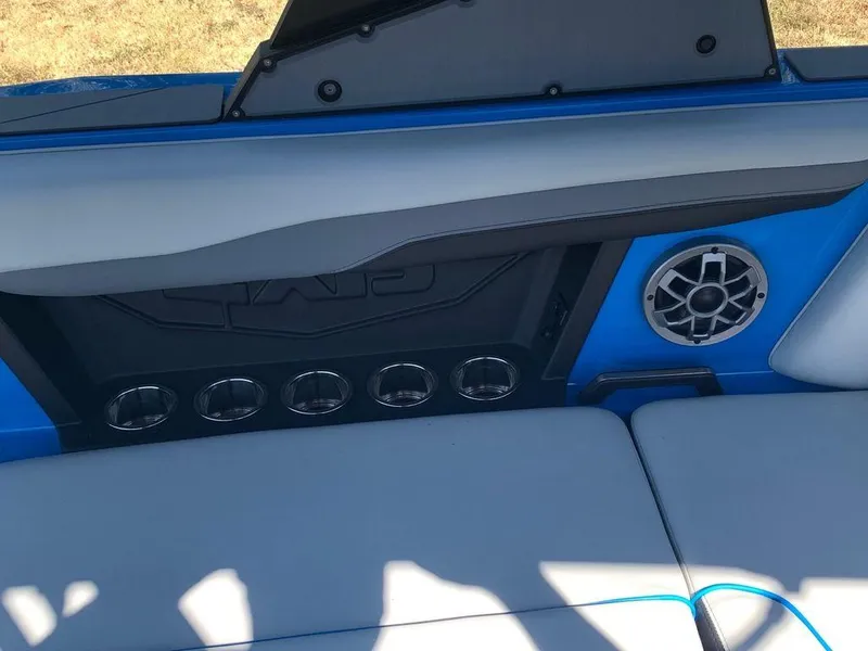 Slide: The Image of 2023 Axis T250 boat interior with cup holders and speaker. - 7