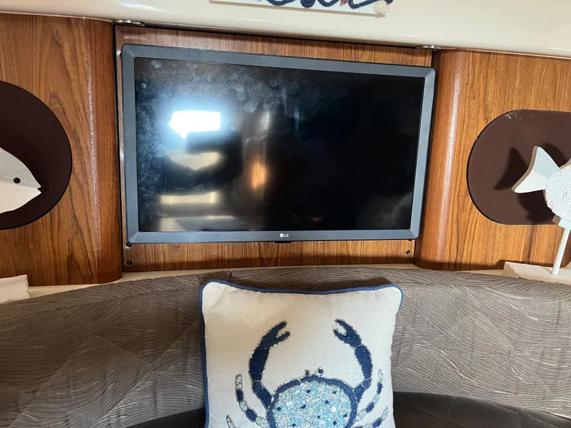 Slide: The Image of Flat-screen TV in 2014 Pursuit 345 OS boat cabin with nautical decor. - 20