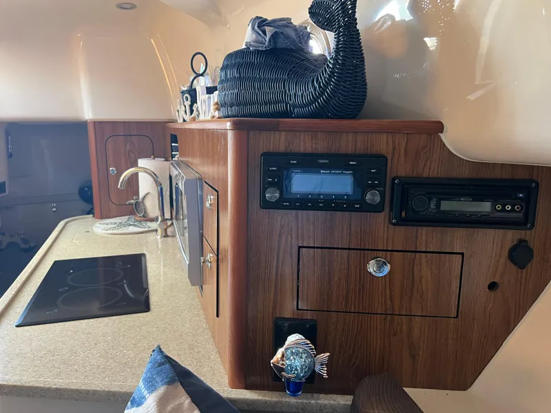 Slide: The Image of Interior of 2014 Pursuit 345 OS boat with kitchen and entertainment system. - 21