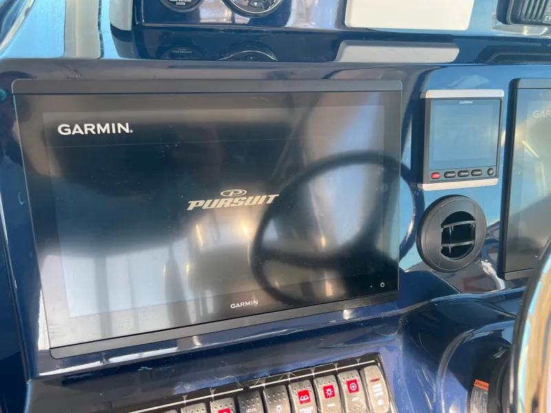 Slide: The Image of Garmin display on 2014 Pursuit 345 OS boat dashboard. - 23
