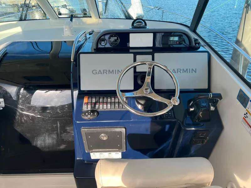 Slide: The Image of 2014 Pursuit 345 OS boat helm with Garmin navigation system. - 26