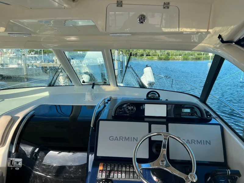 Slide: The Image of 2014 Pursuit 345 OS helm with Garmin navigation system, overlooking marina. - 27