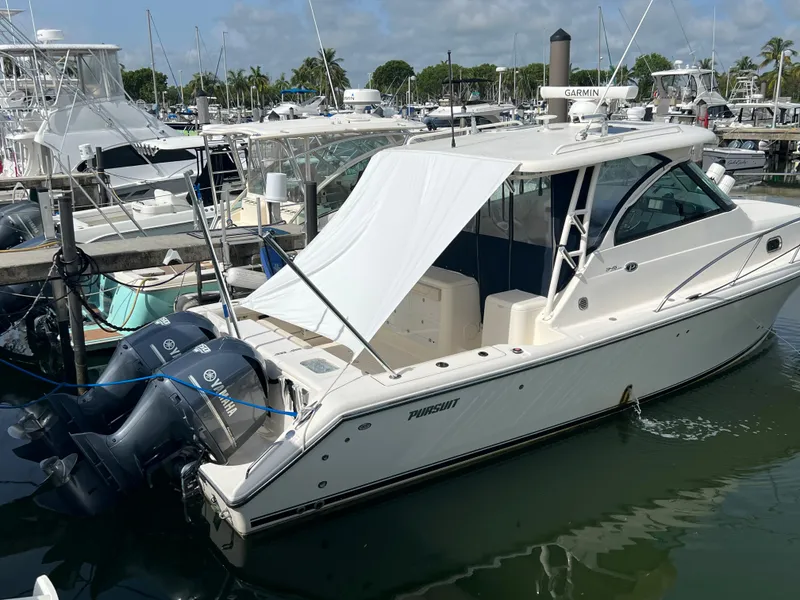 Slide: The Image of 2014 Pursuit 345 OS boat docked with Yamaha outboard engines. - 3