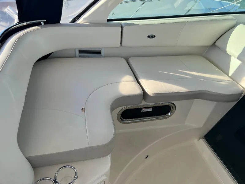 Slide: The Image of 2014 Pursuit 345 OS boat interior seating area with white leather upholstery. - 30