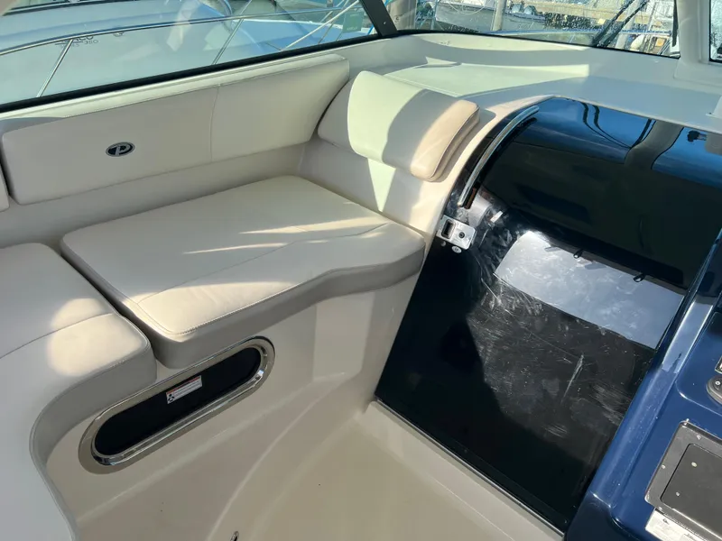 Slide: The Image of 2014 Pursuit 345 OS boat interior with cushioned seating and storage. - 31