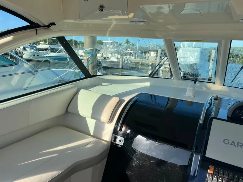Slide: The Image of Interior of 2014 Pursuit 345 OS boat with marina view through windows. - 33