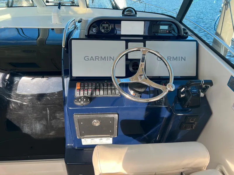 Slide: The Image of 2014 Pursuit 345 OS helm with Garmin navigation system. - 34