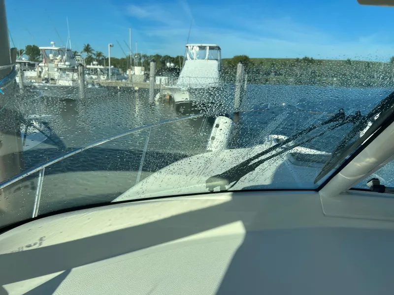 Slide: The Image of View from the helm of a 2014 Pursuit 345 OS boat at a marina. - 36