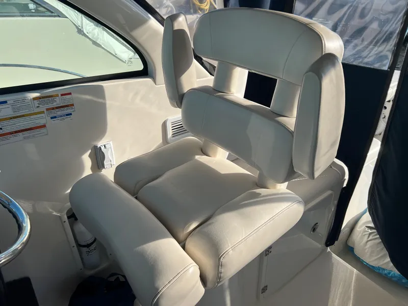 Slide: The Image of 2014 Pursuit 345 OS captain's chair in white leather upholstery. - 38