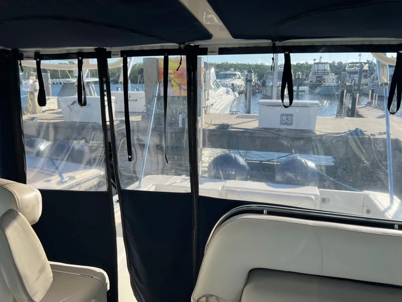 Slide: The Image of Interior view of 2014 Pursuit 345 OS boat with marina in background. - 39