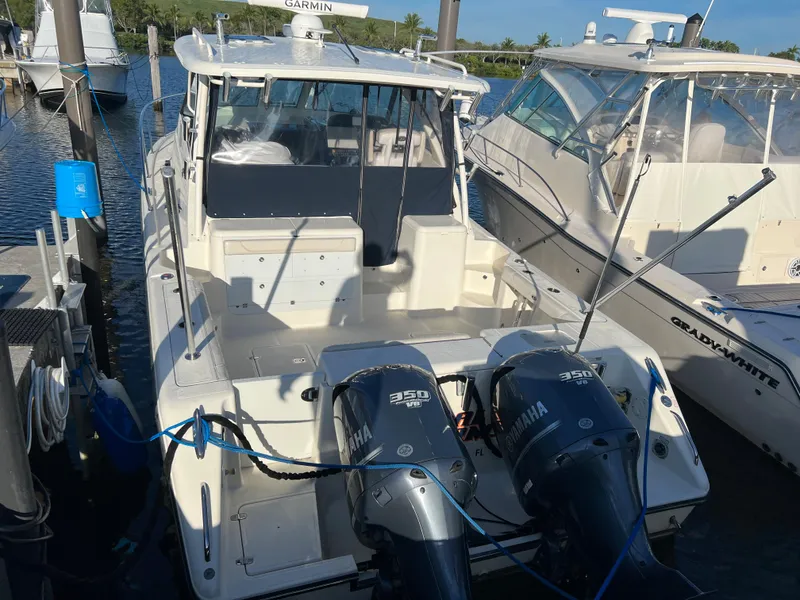 Slide: The Image of 2014 Pursuit 345 OS boat docked with twin Yamaha 350 engines. - 4