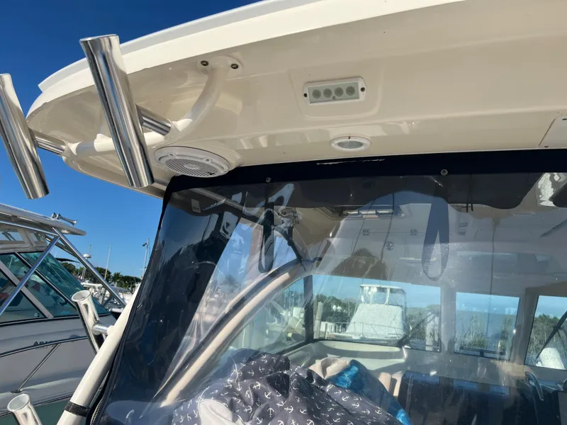 Slide: The Image of 2014 Pursuit 345 OS boat with clear windshield and rod holders. - 45