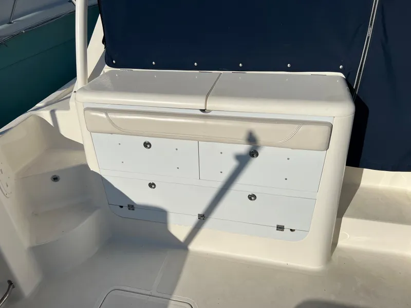 Slide: The Image of 2014 Pursuit 345 OS boat storage compartment with cushioned seating. - 46