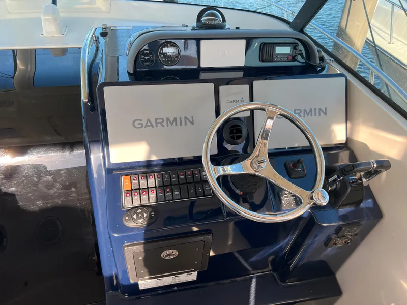 Slide: The Image of 2014 Pursuit 345 OS helm with Garmin navigation system. - 8