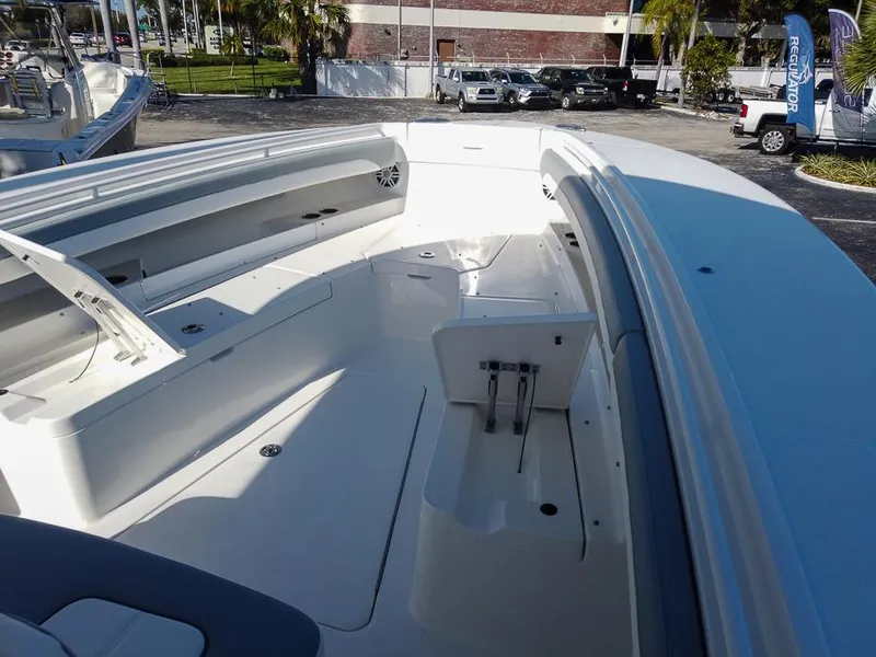 Slide: The Image of 2024 Regulator 31 boat interior, spacious deck with seating and storage compartments. - 13