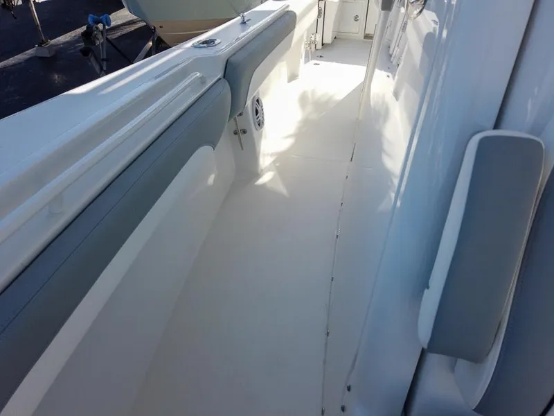 Slide: The Image of 2024 Regulator 31 boat interior, white and gray seating, clean deck. - 15
