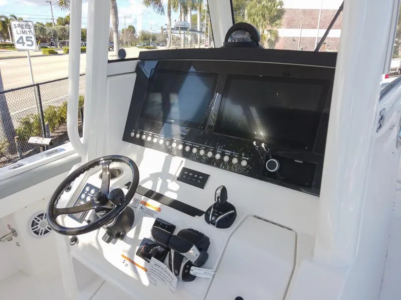 Slide: The Image of 2024 Regulator 31 boat helm with dual screens and controls. - 17