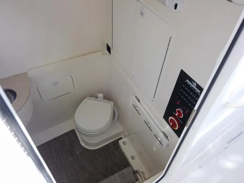 Slide: The Image of 2024 Regulator 31 boat interior bathroom with toilet and control panel. - 22