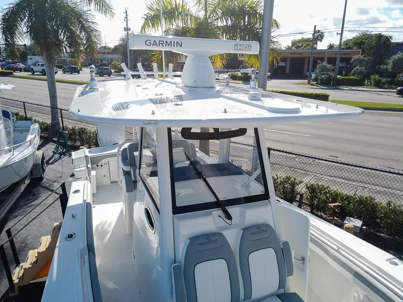 Slide: The Image of 2024 Regulator 31 boat with Garmin radar, docked near palm trees. - 26