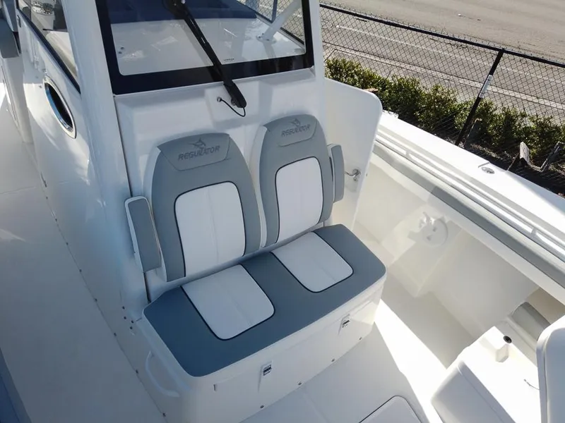 Slide: The Image of 2024 Regulator 31 boat with dual cushioned seats and white interior. - 29