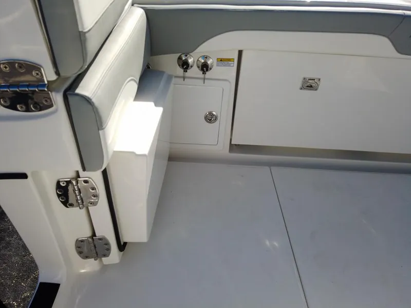 Slide: The Image of 2024 Regulator 31 boat interior, featuring storage compartments and cushioned seating. - 30