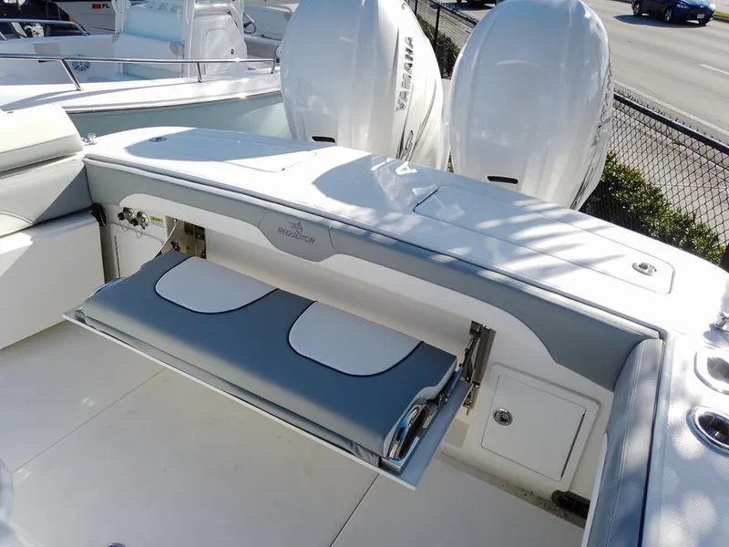 Slide: The Image of 2024 Regulator 31 boat with dual Yamaha engines and fold-out seating. - 31
