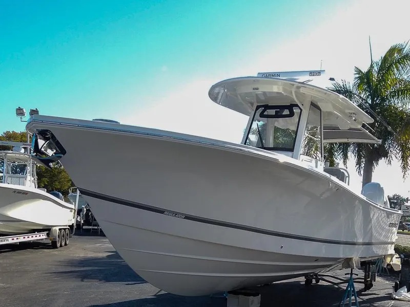 Slide: The Image of 2024 Regulator 31 boat on display in a marina. - 6