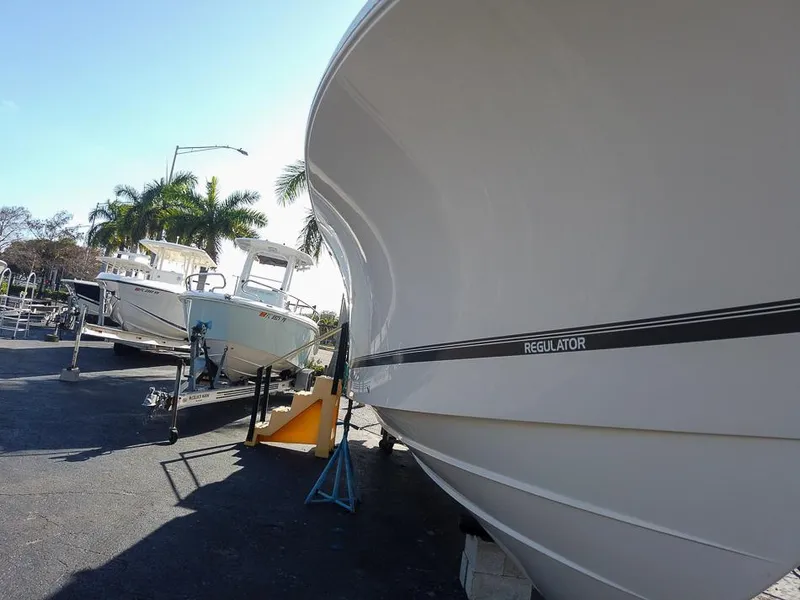 Slide: The Image of 2024 Regulator 31 boat on display in a sunny outdoor setting. - 7