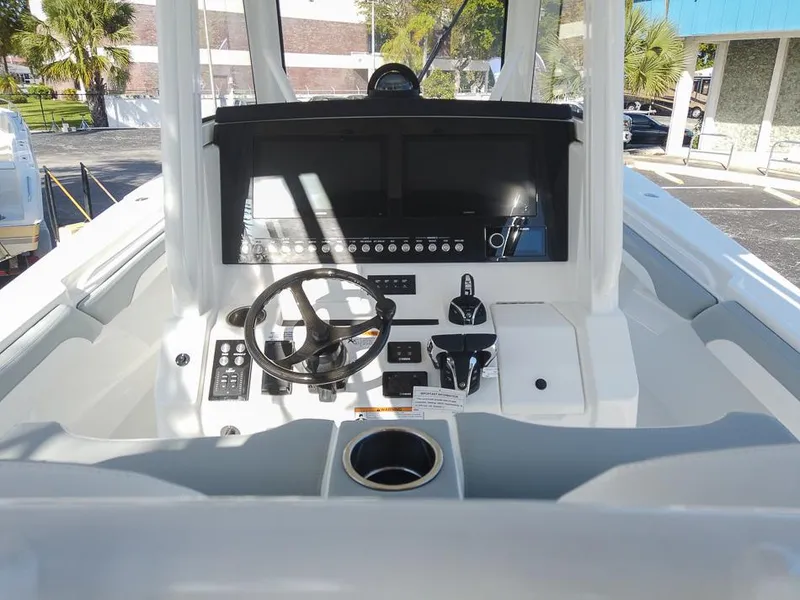Slide: The Image of 2024 Regulator 31 boat helm with steering wheel and control panel. - 9