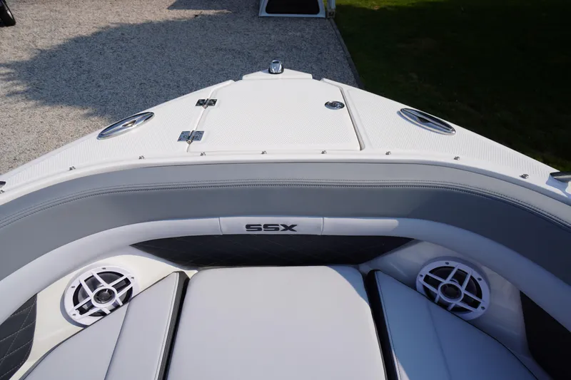 Slide: The Image of 2025 Chaparral 267 SSX boat anchor compartment with chain and winch. - 16
