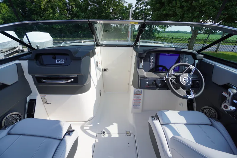 Slide: The Image of 2025 Chaparral 267 SSX boat dashboard with modern steering wheel and digital display. - 27