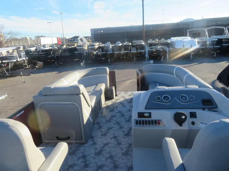 Slide: The Image of 2023 Crest Classic DLX 220 SLSC CPT DLX pontoon boat interior with helm and seating. - 17