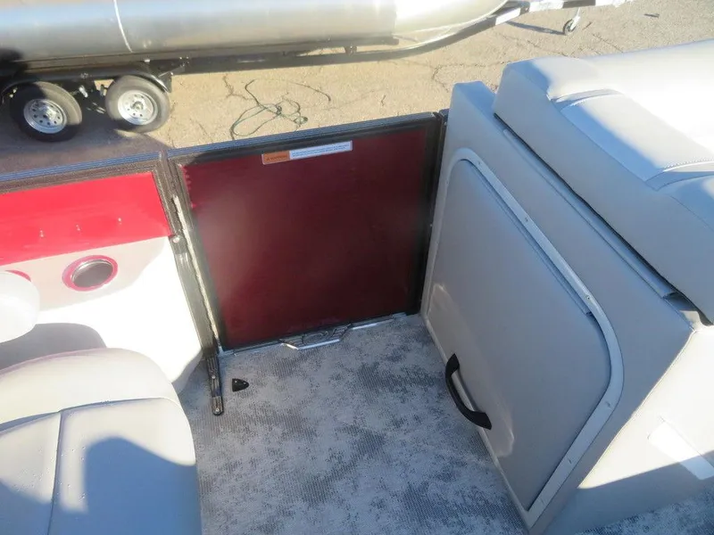 Slide: The Image of 2023 Crest Classic DLX 220 SLSC CPT DLX interior with seating and storage. - 4