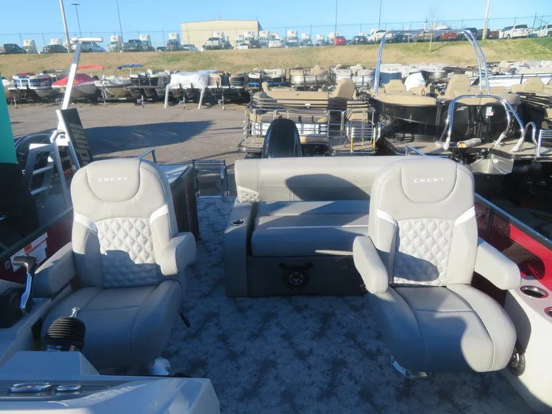 Slide: The Image of 2023 Crest Classic DLX 220 SLSC CPT DLX pontoon boat interior with plush seating. - 6