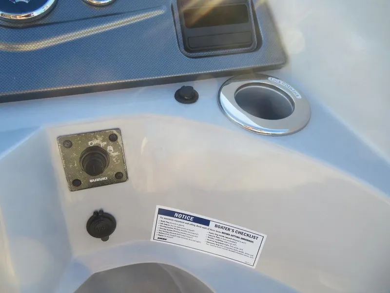 Slide: The Image of 2023 Crest Classic DLX 220 SLSC CPT DLX dashboard with controls and boater's checklist. - 9