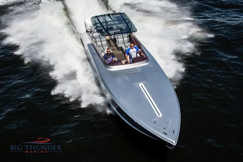 Slide: The Image of 2019 Donzi 41 GT speedboat cruising on water, Big Thunder Marine logo. - 3