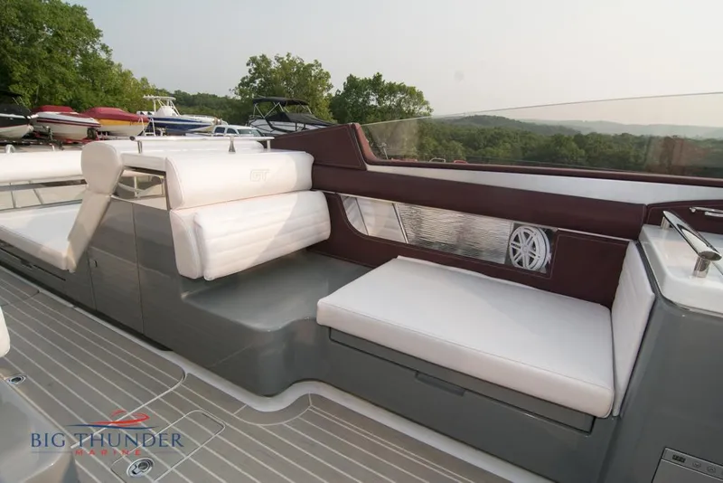 Slide: The Image of 2019 Donzi 41 GT boat interior with white seating and scenic background. - 35