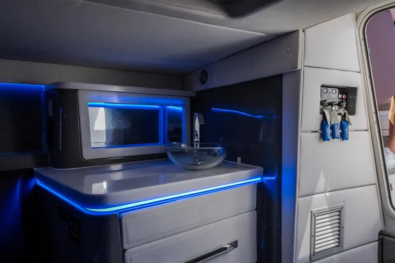 Slide: The Image of Interior of 2019 Donzi 41 GT boat with modern sink and blue LED lighting. - 58